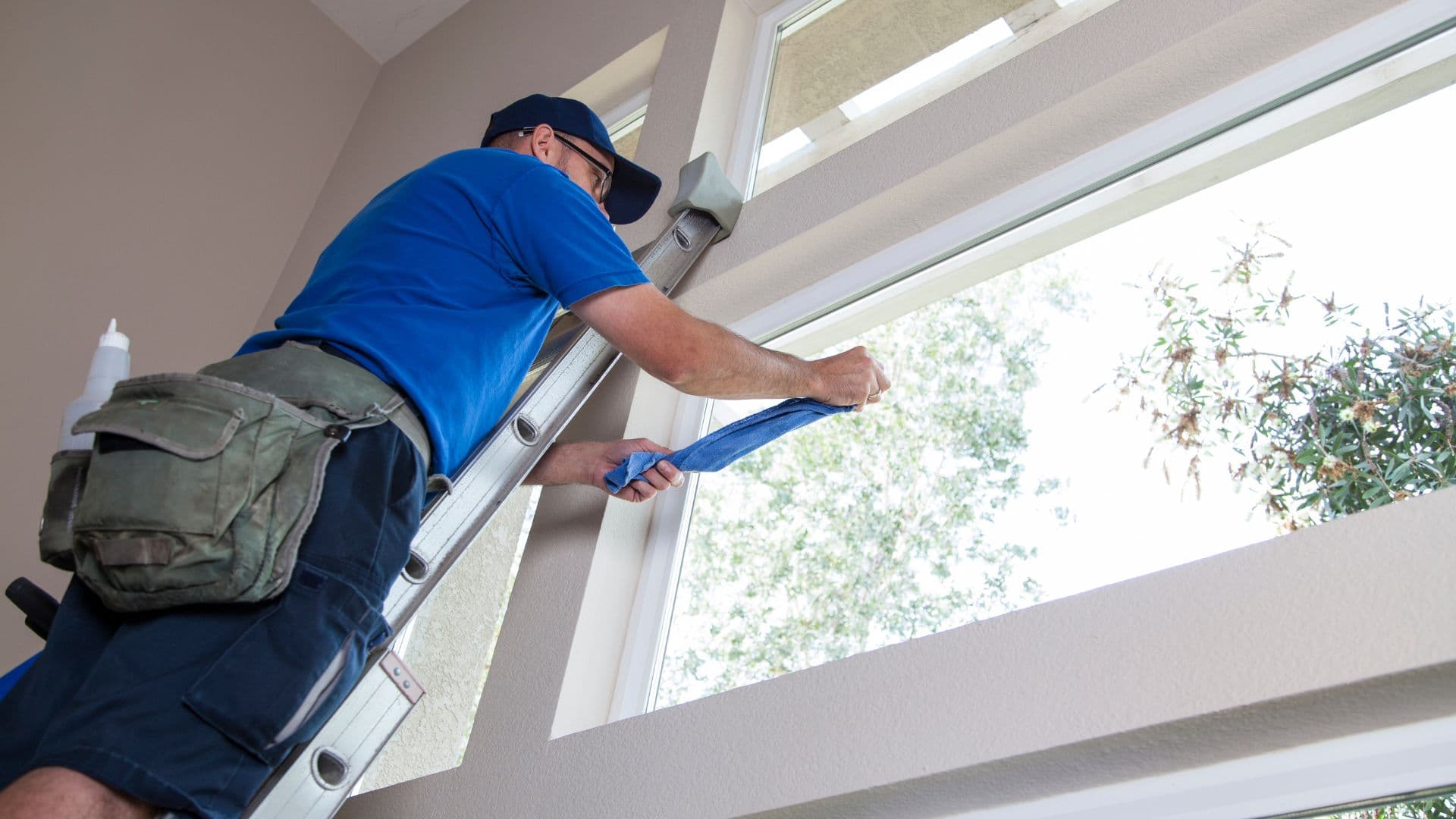 ViewPoint LLC window cleaning technician using a water-fed pole on a two-story brick home in Lynchburg, VA